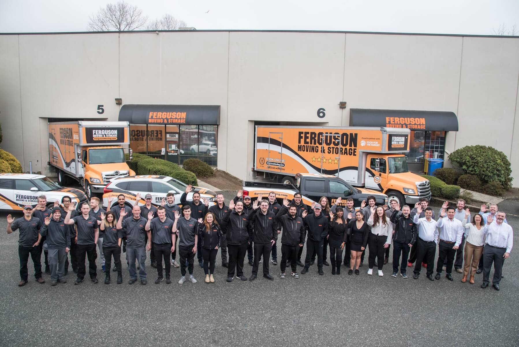 Ferguson Moving & Storage team posing in front of Vancouver office during a photoshoot.